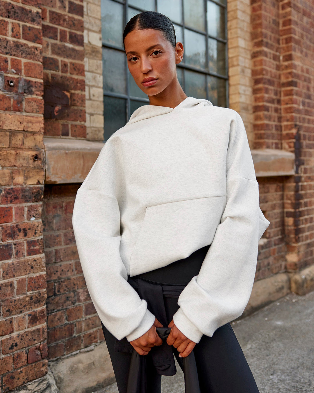 Woman wearing AfterDark ZeroCrease Oversized Hoodie - Silver Marl | Model:Nejilka |Size:XS