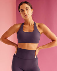Woman wearing Aspire Sports Bra - Midnight Plum | Model:Bruna | Size:XS