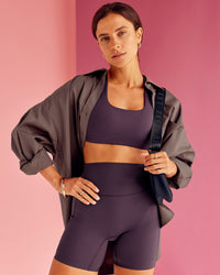 Woman wearing Aspire Sports Bra - Midnight Plum | Model:Bruna | Size:XS