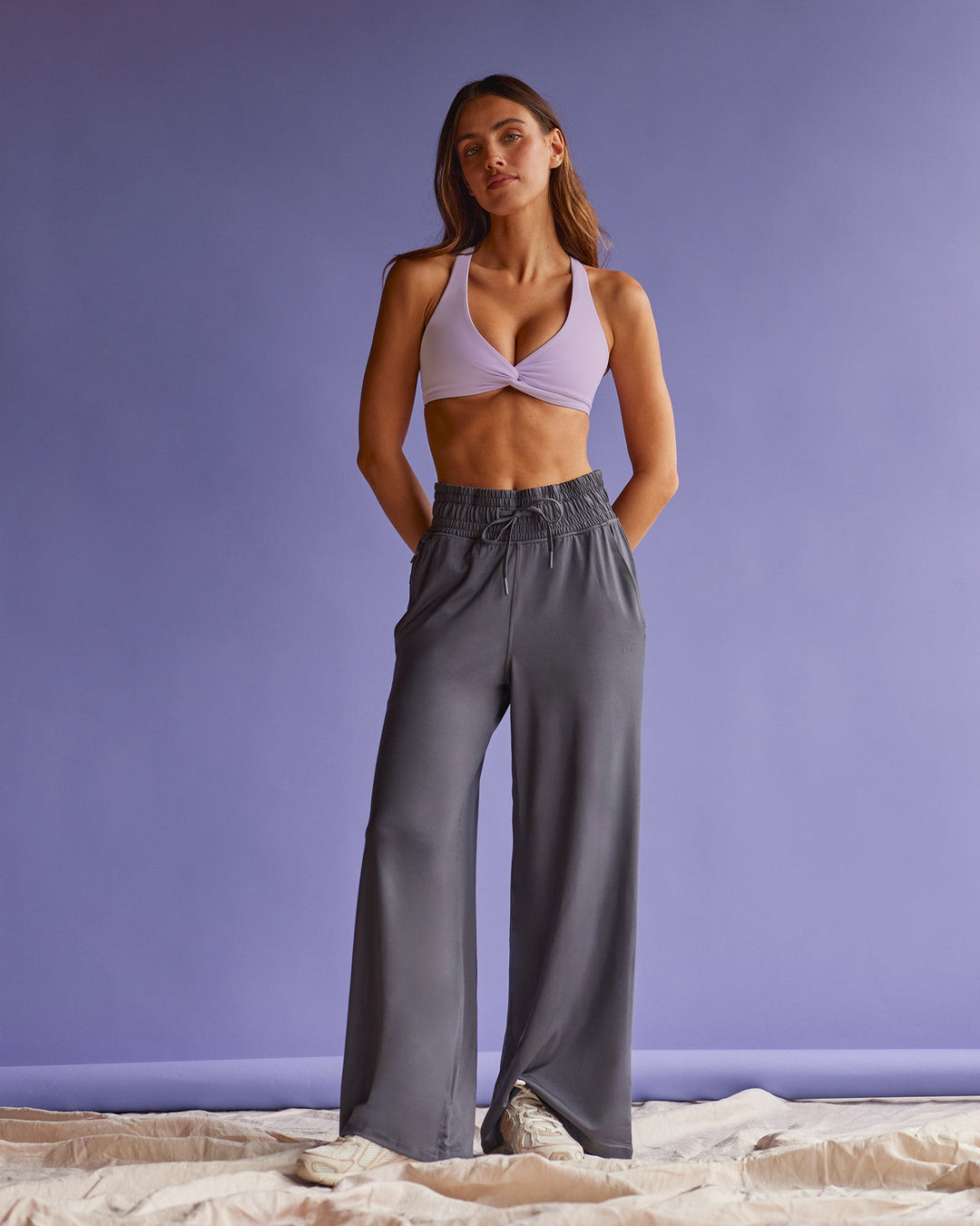 Woman wearing Aspire Twist Sports Bra - Pale Lilac | Model:Beatriz | Size:XS