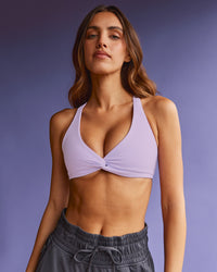 Woman wearing Aspire Twist Sports Bra - Pale Lilac | Model:Beatriz | Size:XS | Thumbnail Index: 1