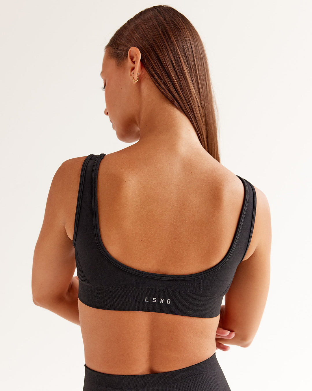 Woman wearing Ember Seamless Sports Bra - Black | Model:Brylee | Size:XS - view 2