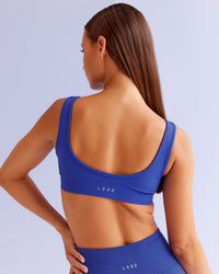 Woman wearing Ember Seamless Sports Bra - Power Cobalt | Model:Brylee | Size:XS | Thumbnail Index: 1