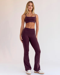 Woman wearing Fusion V-Contour High-Rise Flared Petite Legging Pockets - Cherry Lacquer | Model:Issy | Size:XS | Thumbnail Index: 4