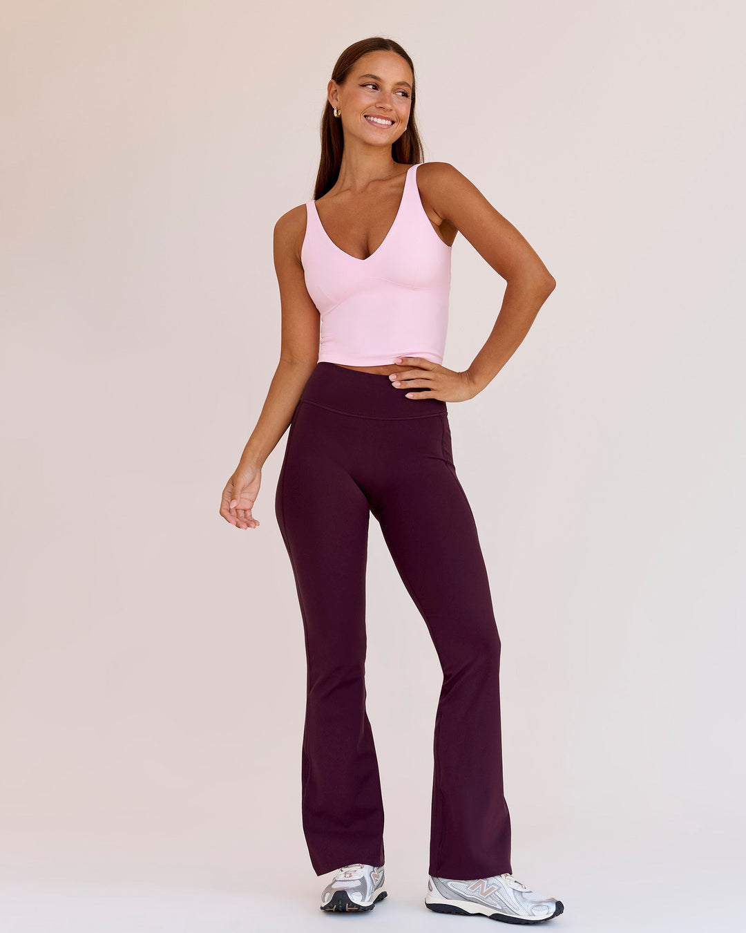 Woman wearing Fusion V-Contour High-Rise Flared Petite Legging Pockets - Cherry Lacquer | Model:Brylee | Size:XS - view 1