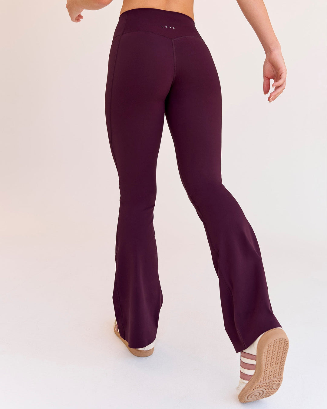 Woman wearing Fusion V-Contour High-Rise Flared Petite Legging Pockets - Cherry Lacquer | Model:Issy | Size:XS - view 3