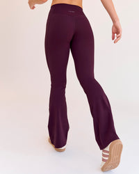 Woman wearing Fusion V-Contour High-Rise Flared Petite Legging Pockets - Cherry Lacquer | Model:Issy | Size:XS | Thumbnail Index: 2