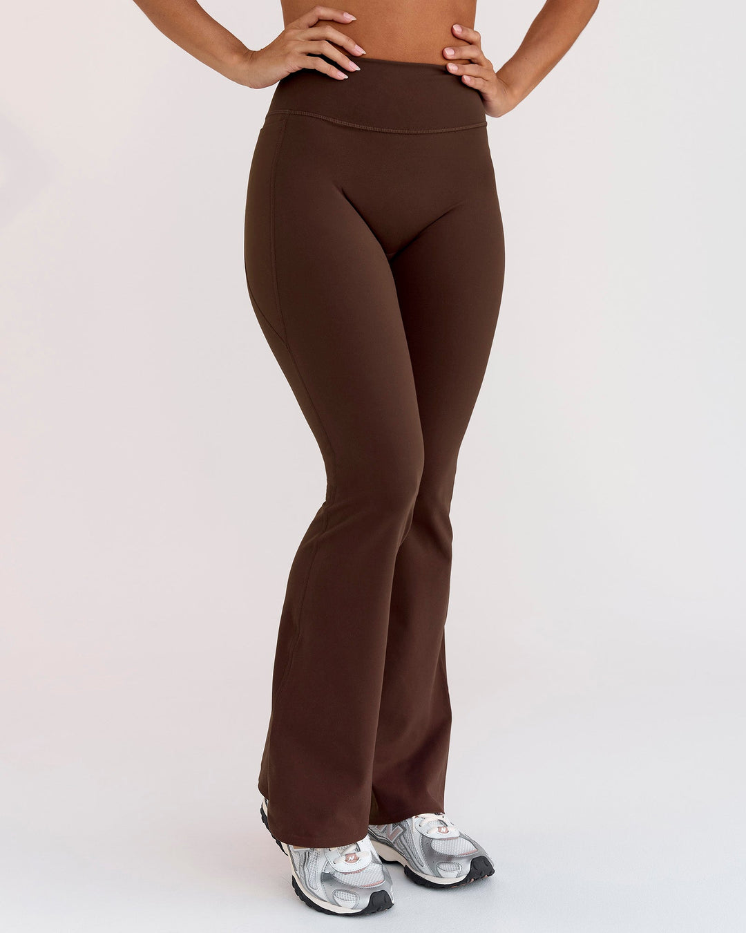 Woman wearing Fusion V-Contour High-Rise Flared Petite Legging Pockets - Hot Chocolate | Model:Brylee | Size:XS