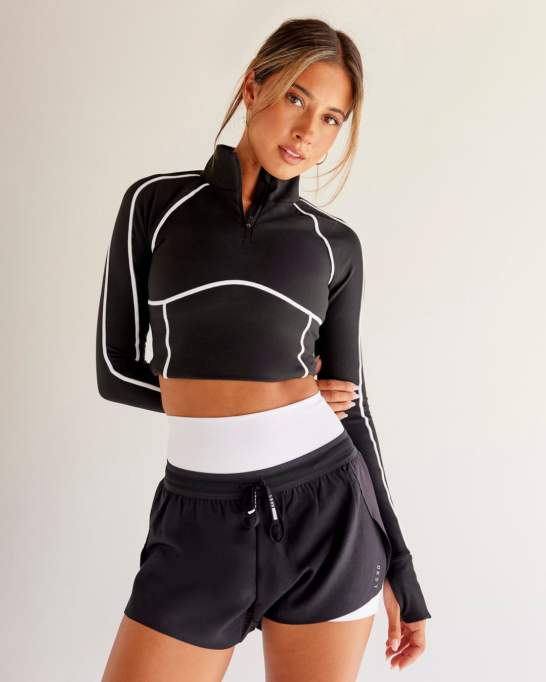 Woman wearing Power Quarter Zip Jacket - Black | Model:Charli | Size:XS - view 4
