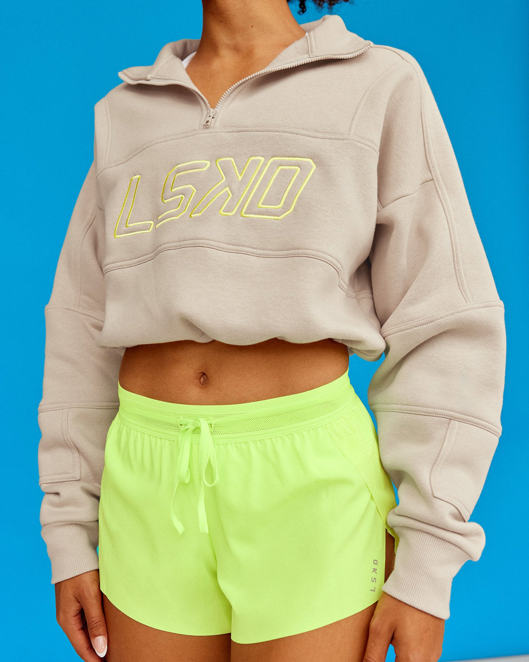 Woman wearing Slam Quarter Zip Sweater - Shale Beige-Lime Glo | Model:Txai | Size:XS