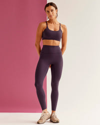 Woman wearing Twist Sports Bra - Midnight Plum | Model:Bruna | Size:XS