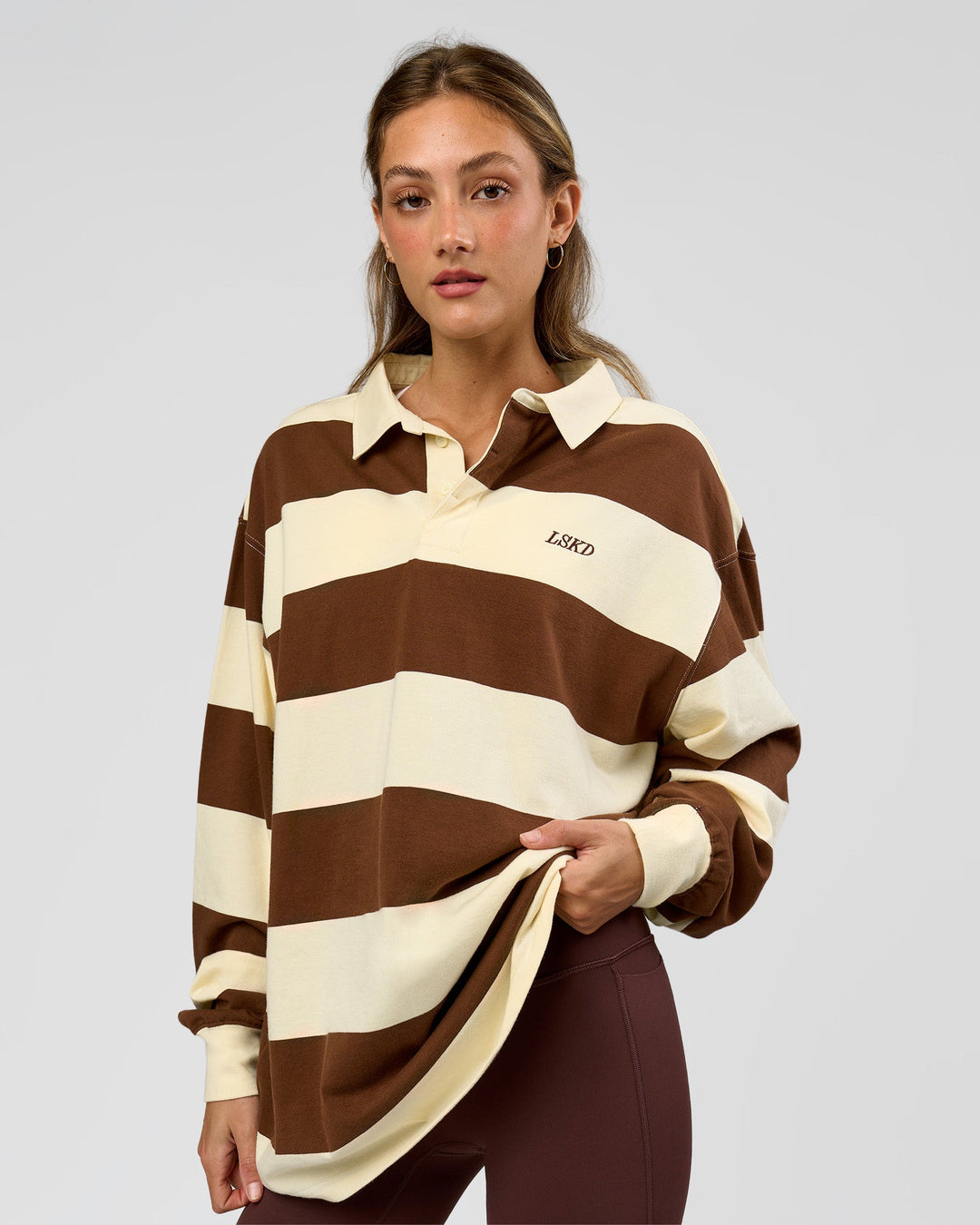 Woman wearing Clubhouse Unisex Polo - Off White-Brown | Model:Georgia| Size:XS