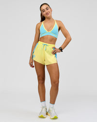 Woman wearing Breeze Sports Bra - Baltic Sea-Lemon | Model:Grace | Size:XS