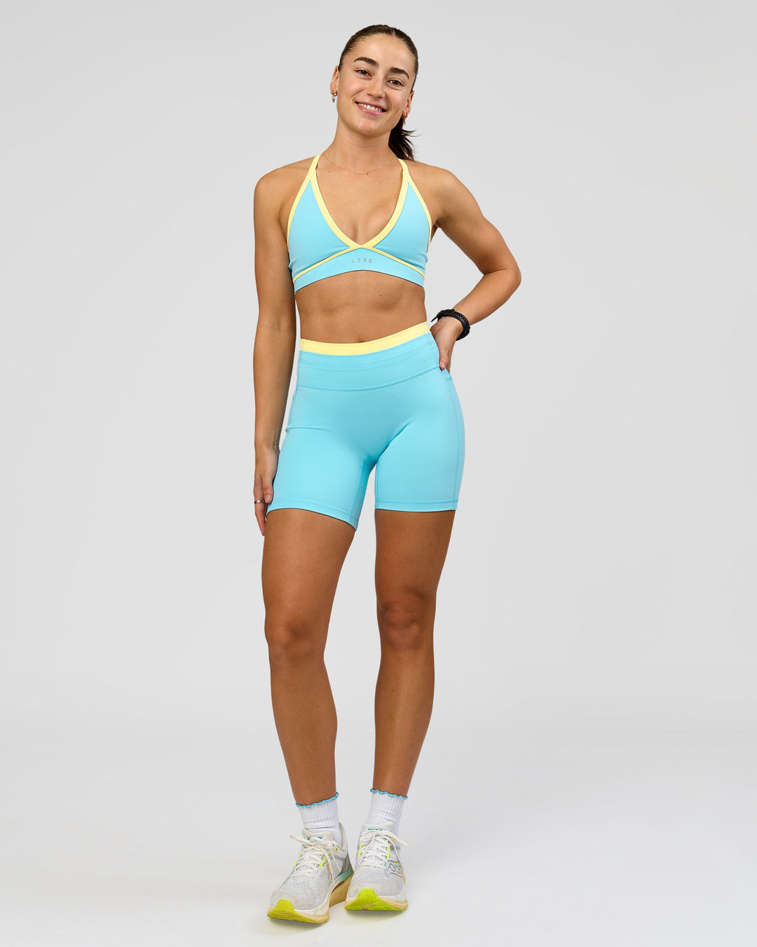 Woman wearing Breeze Sports Bra - Baltic Sea-Lemon | Model:Grace | Size:XS