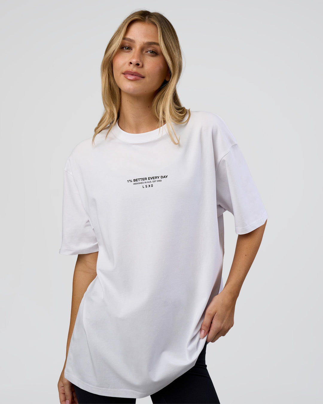 Woman wearing 1% Better Every Day EST FLXCotton Oversized Tee - White | Model:Leilani | Size:XS