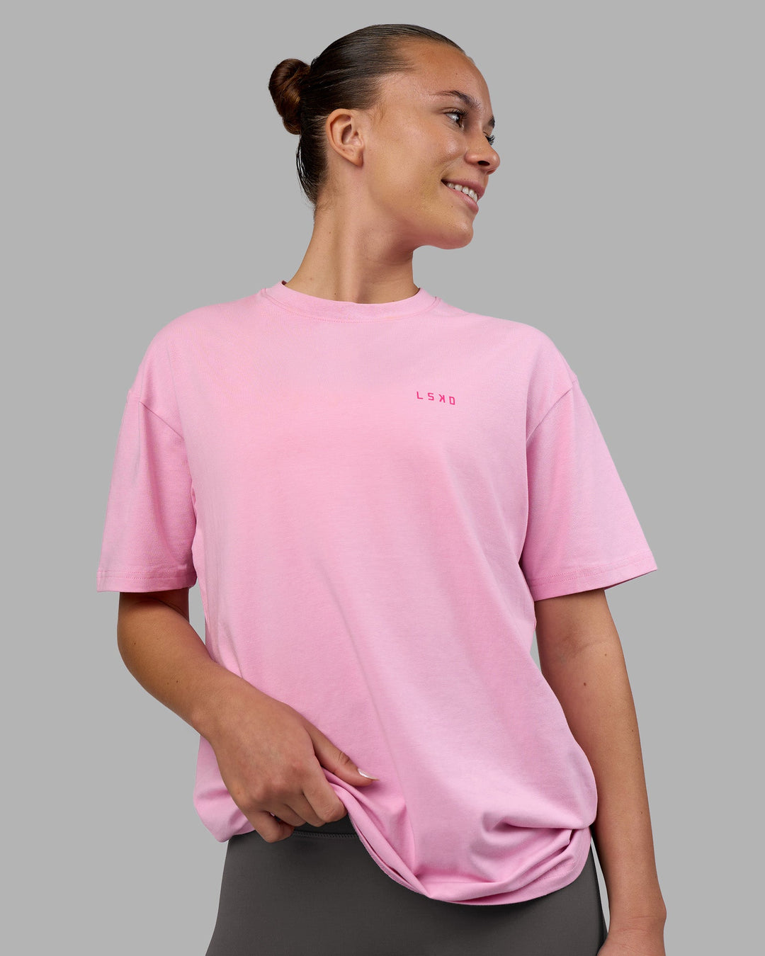 Woman wearing 1% Better Value Series FLXCotton Tee Oversize - Bubblegum-Ultra Pink | Model:Charlize | Size:XS