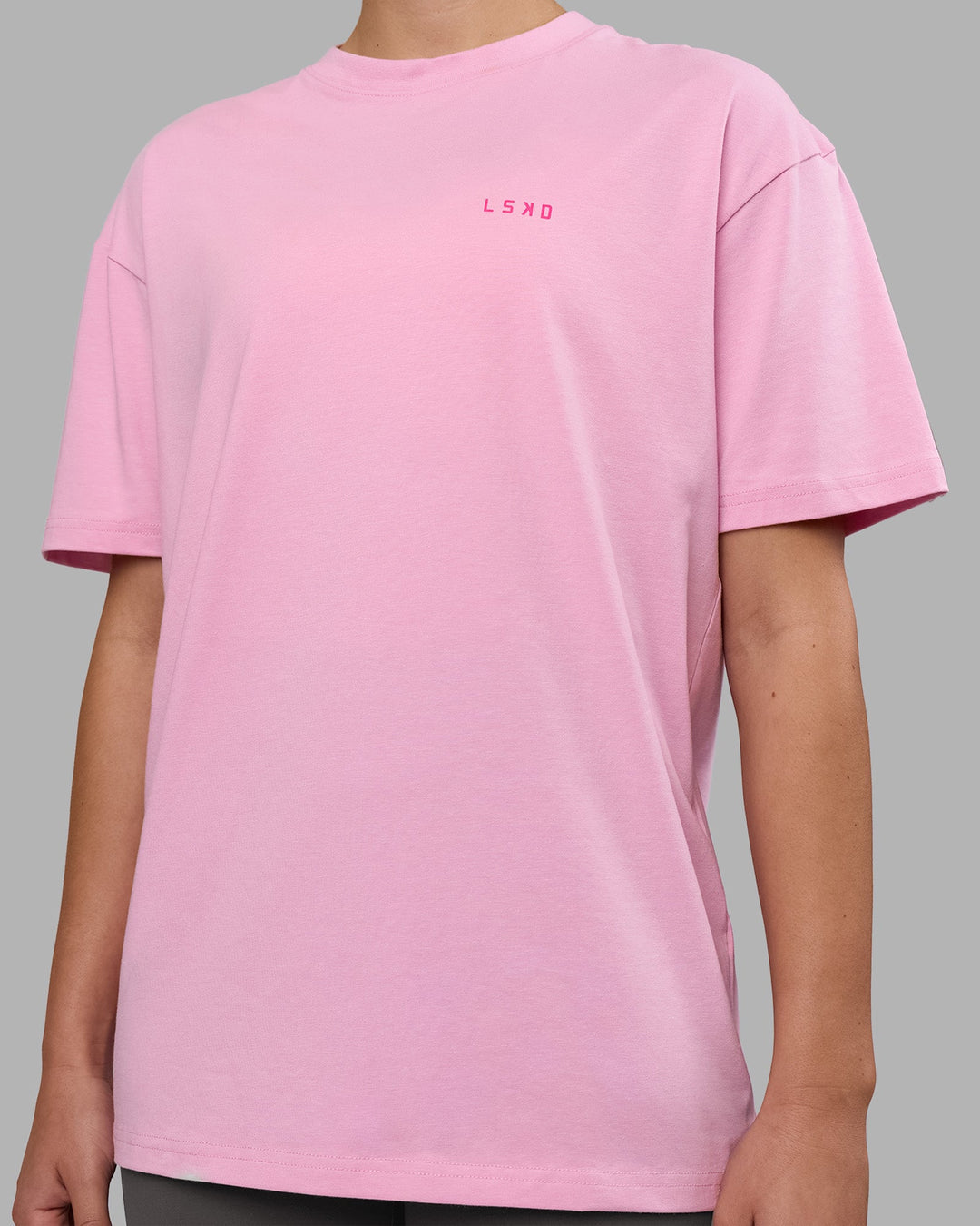 Woman wearing 1% Better Value Series FLXCotton Tee Oversize - Bubblegum-Ultra Pink | Model:Charlize | Size:XS