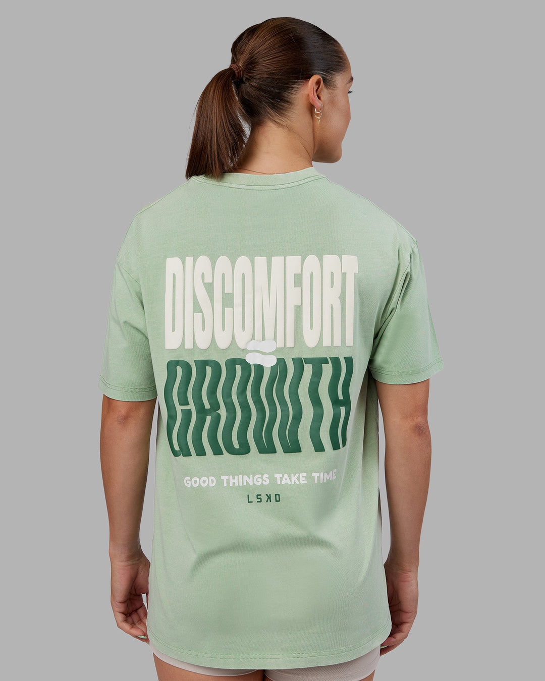 Woman wearing Abs Unisex Growth FLXCotton Oversized Tee - Matcha Green Washed | Model:Abbey | Size:XS