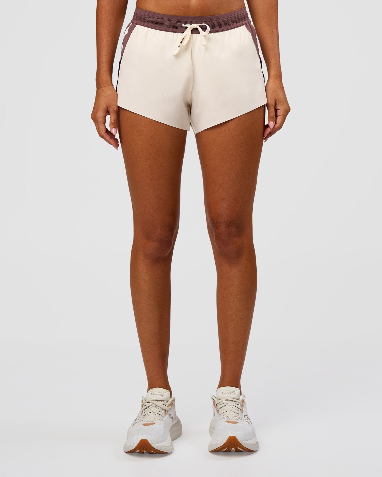 Woman wearing Accelerate 3" Force Mid-Rise Running Short - Cocoa powder-Off White | Set:true | Angle:front | Model:Charli | Size:XS