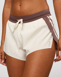 Woman wearing Accelerate 3" Force Mid-Rise Running Short - Cocoa powder-Off White | Set:true | Angle:closeup | Model:Charli | Size:XS
