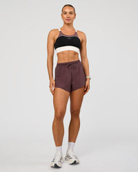 Woman wearing Accelerate 3" High-Rise Running Short - Cocoa Powder | Model:Maja | Size:XS
