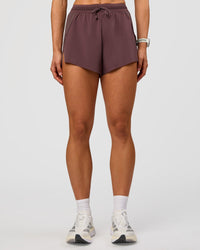 Woman wearing Accelerate 3" High-Rise Running Short - Cocoa Powder | Set:true | Angle:front | Model:Maja | Size:XS