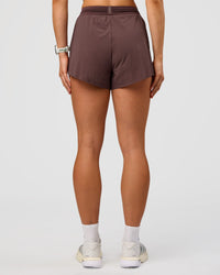 Woman wearing Accelerate 3" High-Rise Running Short - Cocoa Powder | Set:true | Angle:back | Model:Maja | Size:XS
