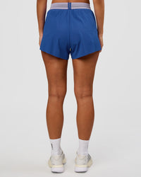 Woman wearing Accelerate 3" High-Rise Running Short - Electric Indigo-Multi | Set:true | Angle:back | Model:Brylee | Size:XS