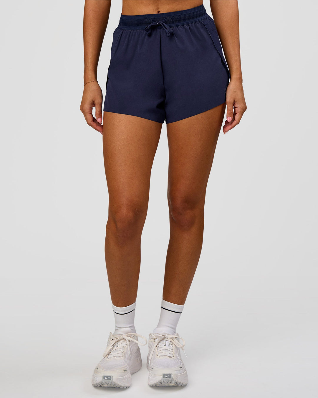 Woman wearing Accelerate 3" High-Rise Running Short in Future Navy | Model:Charli | Size:XS