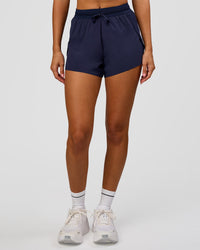 Woman wearing Accelerate 3" High-Rise Running Short in Future Navy | Model:Charli | Size:XS