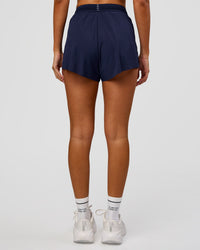 Woman wearing Accelerate 3" High-Rise Running Short in Future Navy | Model:Charli | Size:XS