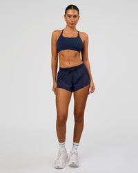 Woman wearing Accelerate 3" High-Rise Running Short in Future Navy | Model:Charli | Size:XS