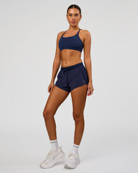 Woman wearing Accelerate 3" High-Rise Running Short in Future Navy | Model:Charli | Size:XS