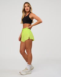 Woman wearing Accelerate 3" High-Rise Running Short in Hyper Green | Model:Issy | Sizze:XS