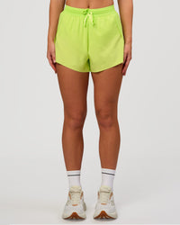 Woman wearing Accelerate 3" High-Rise Running Short in Hyper Green | Model:Issy | Sizze:XS