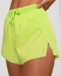 Woman wearing Accelerate 3" High-Rise Running Short in Hyper Green | Model:Issy | Sizze:XS