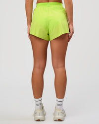 Woman wearing Accelerate 3" High-Rise Running Short in Hyper Green | Model:Issy | Sizze:XS