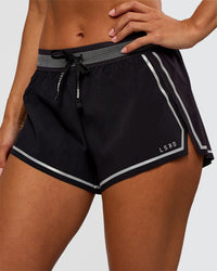 Woman wearing Accelerate 3" Reflective Mid-Rise Running Short - Black-Reflective | Set:true | Angle:closeup | Model:Brylee | Size:XS