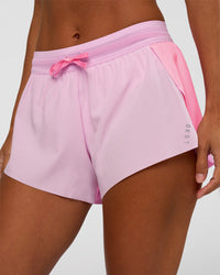Woman wearing Accelerate 3" Mid-Rise Running Short - Candy Pink-Marshmallow | Set:true | Angle:closeup | Model:Brylee | Size:XS