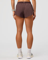 Woman wearing Accelerate 3" Mid-Rise Running Short - Cocoa Powder | Set:true | Angle:back | Model:Maja | Size:XS