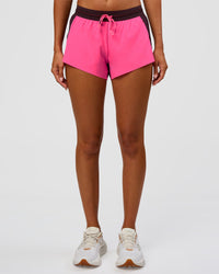 Woman wearing Accelerate 3" Mid-Rise Running Short - Midnight Plum-Sugar Plum | Set:True | Angle:front | Model:Charli | Size:XS