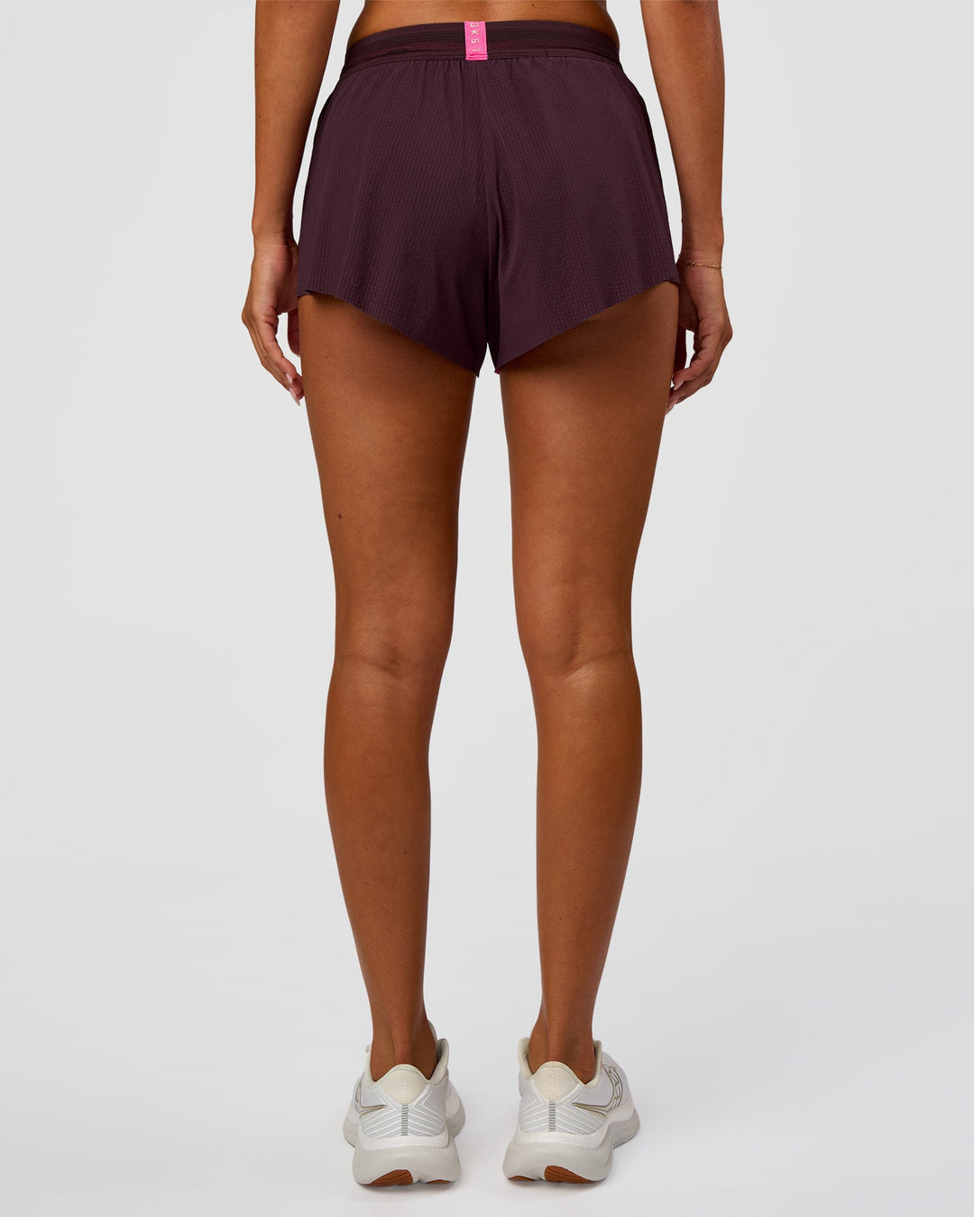 Woman wearing Accelerate 3" Mid-Rise Running Short - Midnight Plum-Sugar Plum | Set:True | Angle:back | Model:Charli | Size:XS