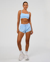 Woman wearing Accelerate 3" Mid-Rise Running Short in Open Air | Model:Charli | Size:XS