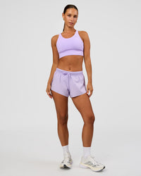 Woman wearing Accelerate 3" Mid-Rise Running Short - Pale Lilac | Model:Brylee | Size:XS