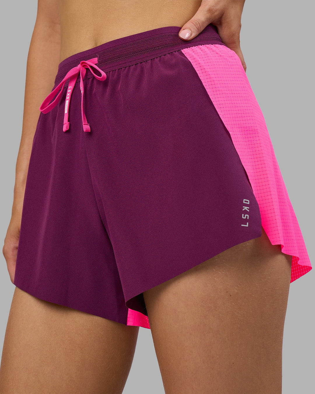 Woman wearing Accelerate 3&quot; High-Rise Running Short - Ultra Pink-Plum Caspia | Model:Leilani | Size:XS