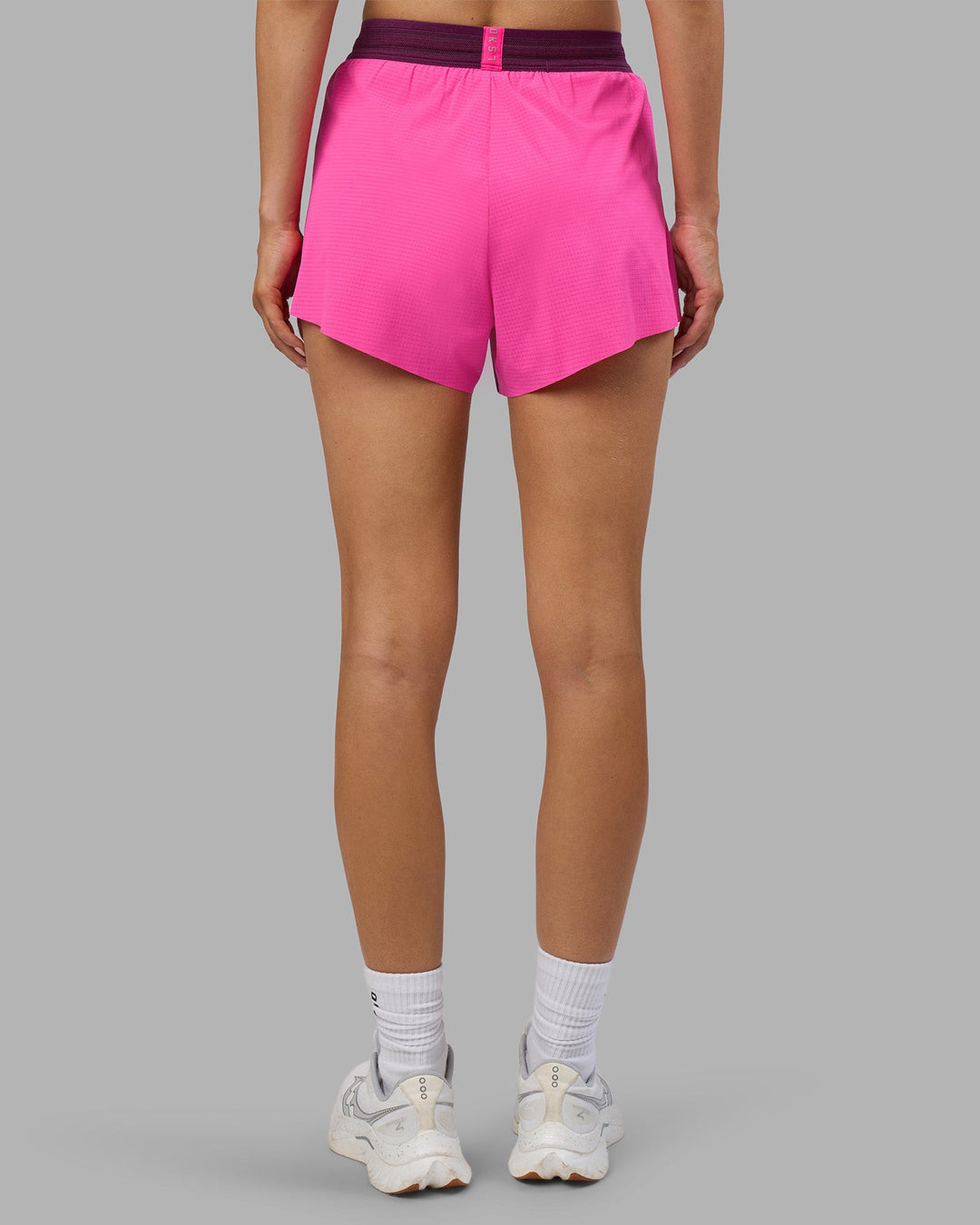 Woman wearing Accelerate 3&quot; High-Rise Running Short - Ultra Pink-Plum Caspia | Model:Leilani | Size:XS