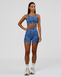 Woman wearing Accelerate Sports Bra in Energy Print Blue Multi | Model:Brylee | Size:XS | Thumbnail Index: 2