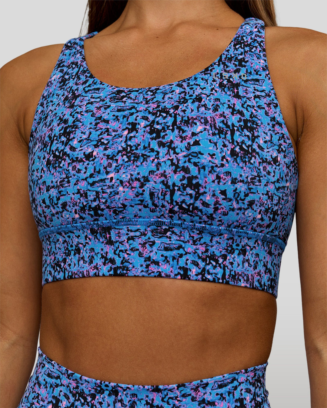 Woman wearing Accelerate Sports Bra in Energy Print Blue Multi | Model:Brylee | Size:XS - view 1