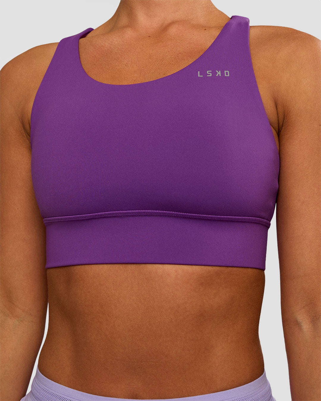 Woman wearing Accelerate Sports Bra - Fresh Purple | Set:true | Angle:closeup | Model:Brylee | Size:XS