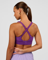 Woman wearing Accelerate Sports Bra - Fresh Purple | Set:true | Angle:back | Model:Brylee | Size:XS